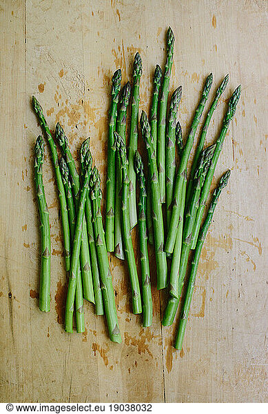 Bunch of fresh cut garden asparagus on a wooden cutting board