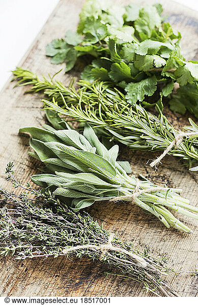 Bunch of fresh herbs on wooden table at home
