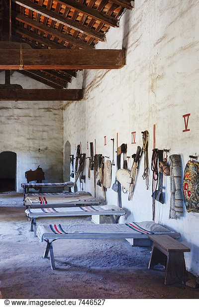Bunkhouse or sleeping room with cots and riding tack at Mission La Purisima State Historic Park  Lompoc  California  Founded in 1787  the eleventh mission of the twenty-one Spanish Missions established in California