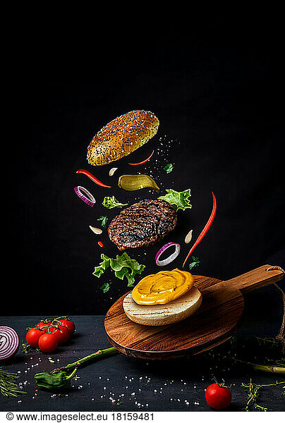Burger with flying ingredients. Burger levitation. Minimal concept