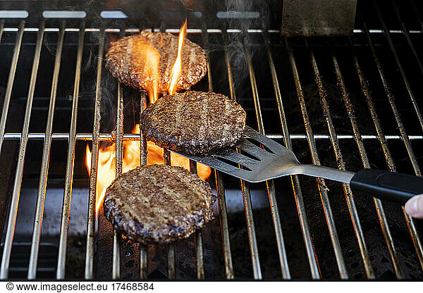 Burgers cooking on barbecue grill