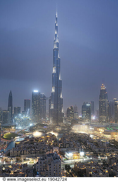 Burj Khalifa and Dubai Skyline under lights during blue hour