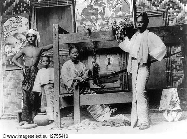 BURMA: WEAVING  c1890. Weaving inside a Burmese house: a group portrait of a woman seated at the loom  a woman standing in front of it and a young man and a girl standing to the left. Photograph  c1890.