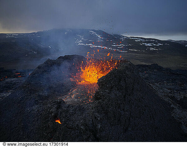 Burning lava splashing in rough volcano crater