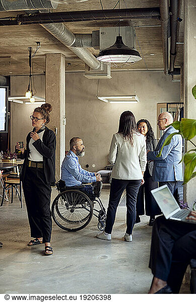 Business colleague discussing during meeting at creative office
