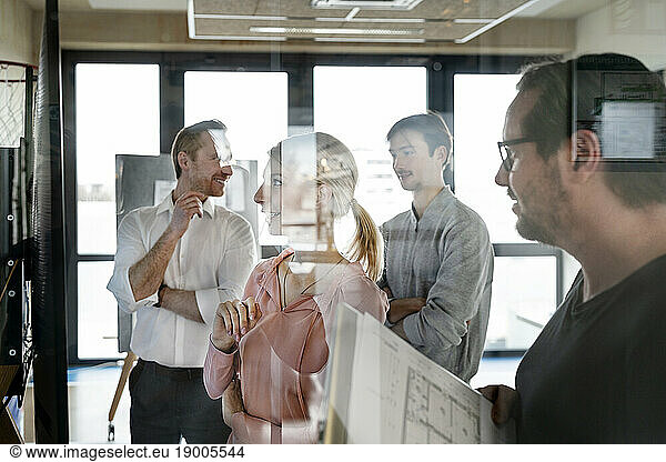 Business colleagues having discussion together in office