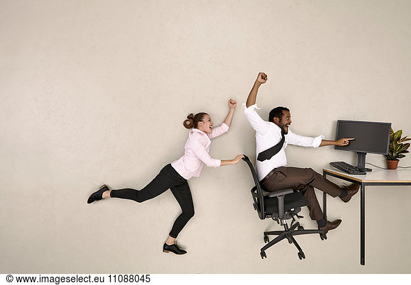 Business colleagues shouting at computer
