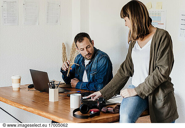 Business couple discussing about strategy while working at home
