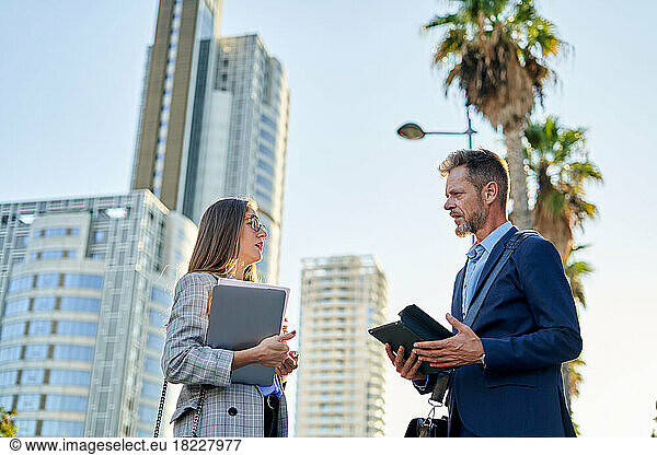 Business man and woman coworkers in front of office building
