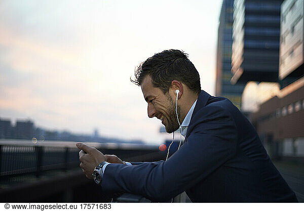 Business man at dawn in the city in a call on his mobile