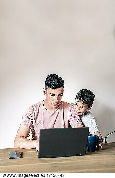 Business man working at home with kids