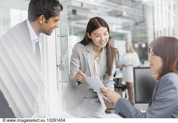 Business people discussing paperwork in office