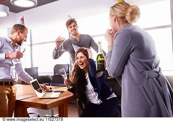 Business people drinking champagne  celebrating birthday in conference room