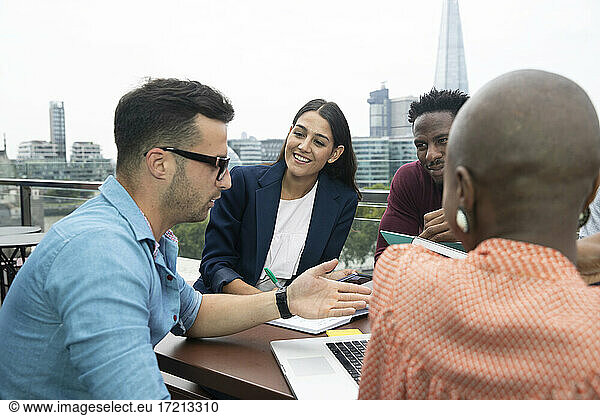 Business people meeting on urban office balcony  London  UK