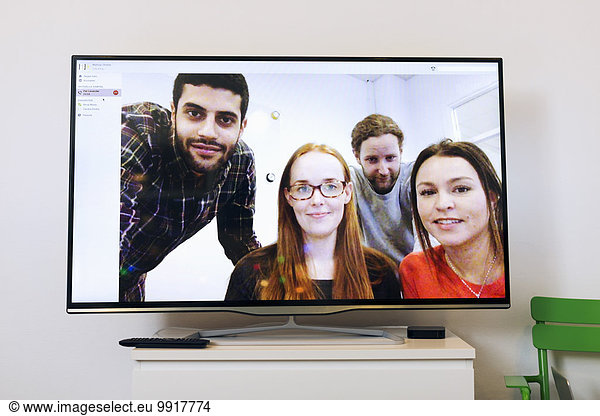 Business people on screen in video conference room at creative office