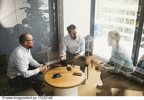 Business people planning strategy while discussing during meeting at office