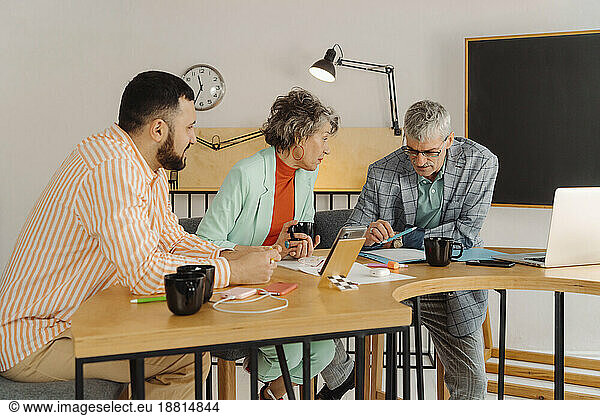 Business people recording online stream sitting at desk in the studio