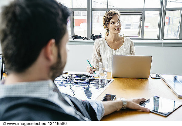 Business people sitting in board room during meeting