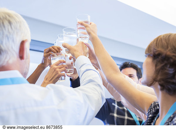 Business people toasting water glasses