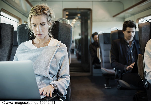 Business people traveling in train