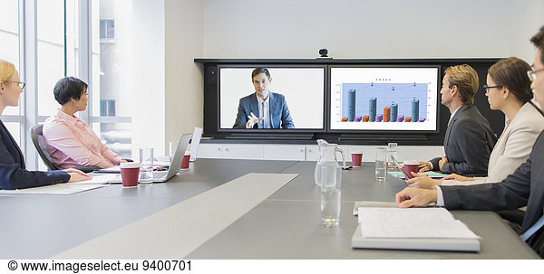Business people using teleconference in meeting