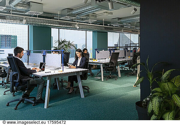 Business people working at desk in coworking space
