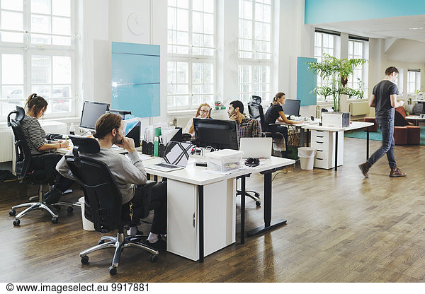 Business people working at desks in creative office