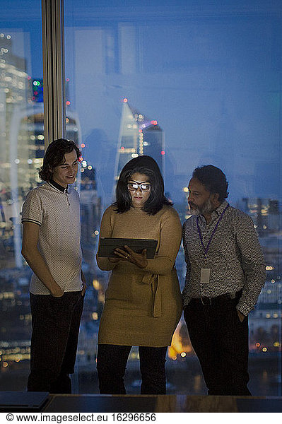 Business people working late in highrise office  London  UK