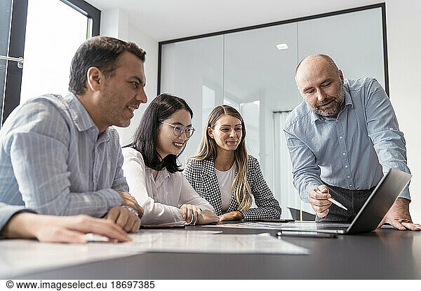Business people working together on laptop in office