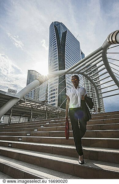 Business woman on Chong Nonsi pedestrian bridge in Bangkok