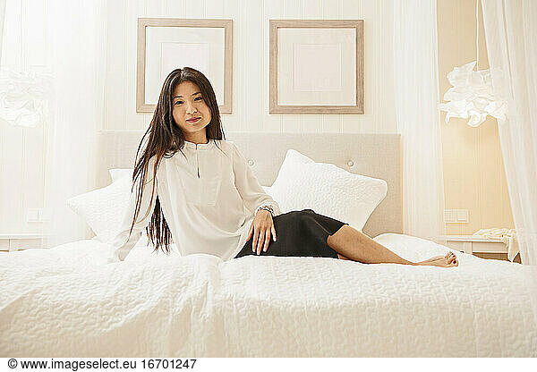 business woman relaxing on bed at luxury hotel in Iceland