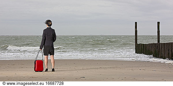 business woman standing on empty beach