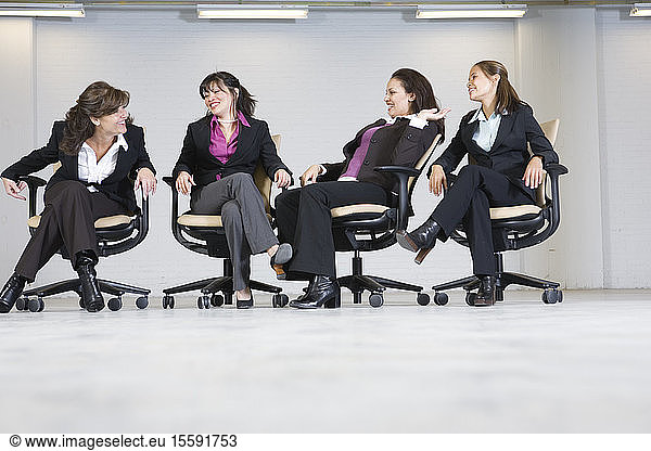 Business women laughing in office.