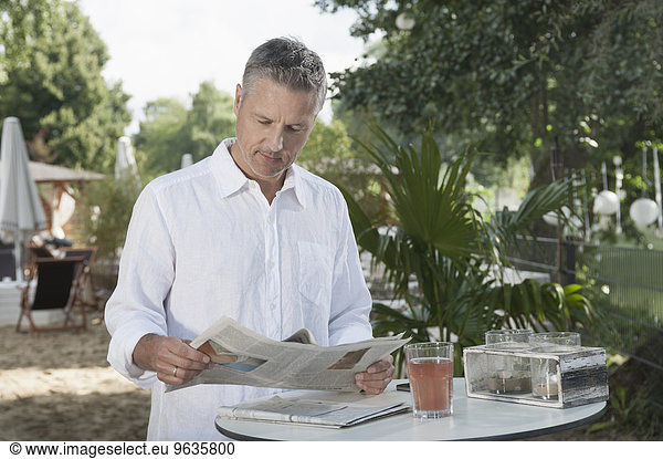 Businessman casual clothing reading newspaper