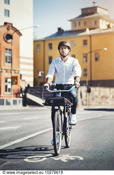 Businessman commuting on bicycle in city