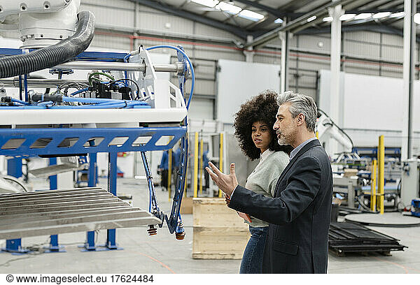 Businessman discussing with engineer in factory