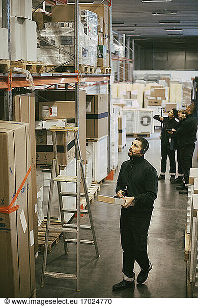 Businessman examining at distribution warehouse