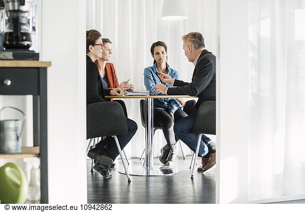 Businessman explaining business strategy to colleagues in meeting