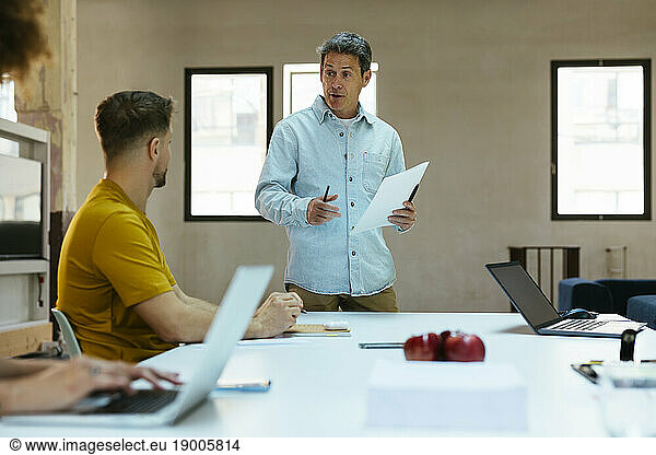 Businessman having meeting with colleagues in office