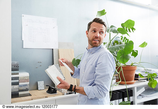 Businessman holding diary working at creative office
