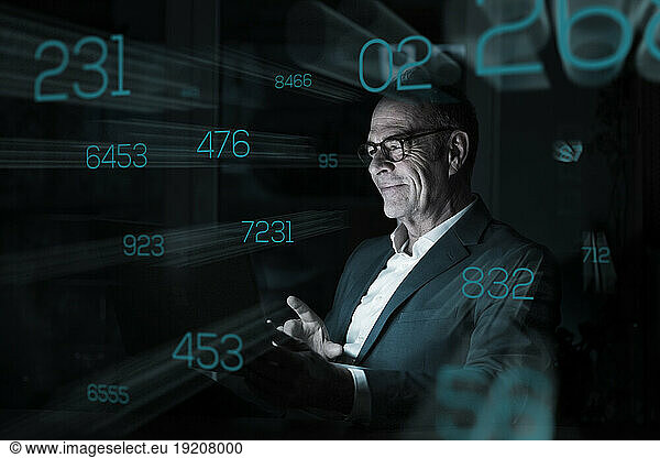 Businessman looking at numbers on graphical user interface