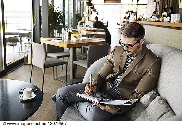Businessman planning while sitting in cafe