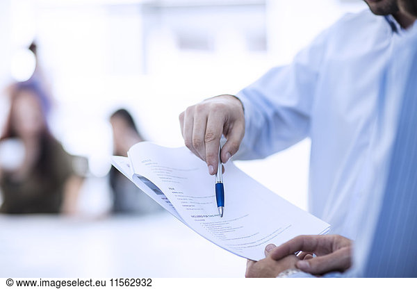 Businessman pointing with pen on contract