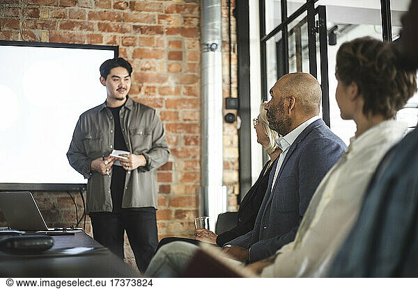Businessman presenting ideas with colleagues at startup company