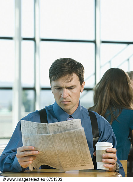 Businessman reading newspaper