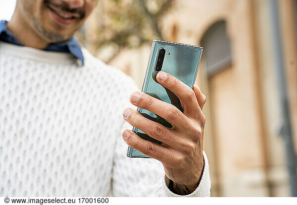 Businessman's hand holding smart phone