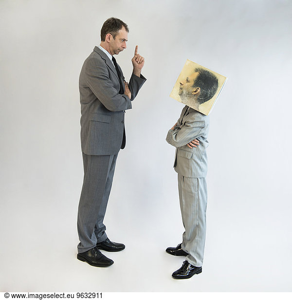 Businessman scolding boy wearing mask