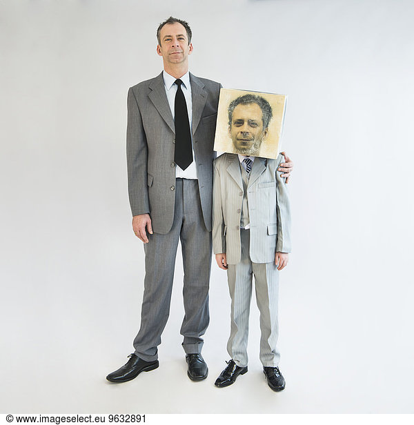 Businessman showing unity and standing near boy wearing mask