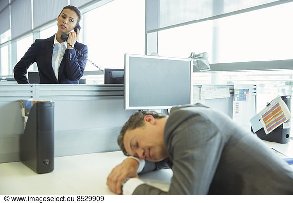 Businessman sleeping at desk in office