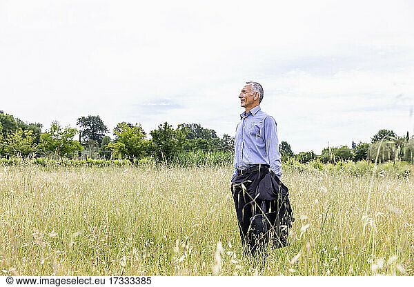 Businessman standing in field